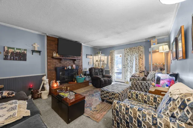 a living room with furniture fireplace and flat screen tv