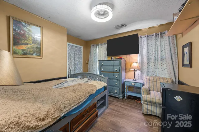 a bedroom with a bed and a flat screen tv