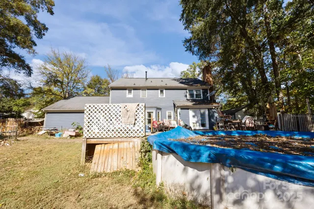 a view of a house with backyard water fountain and sitting area