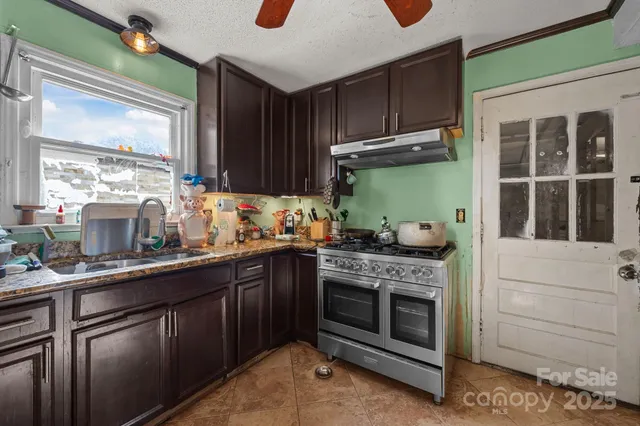 a kitchen with stainless steel appliances granite countertop a stove and a sink