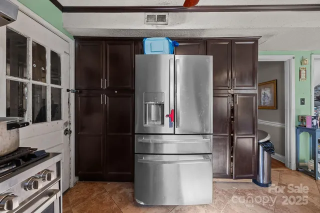 a kitchen with stainless steel appliances a refrigerator and a stove
