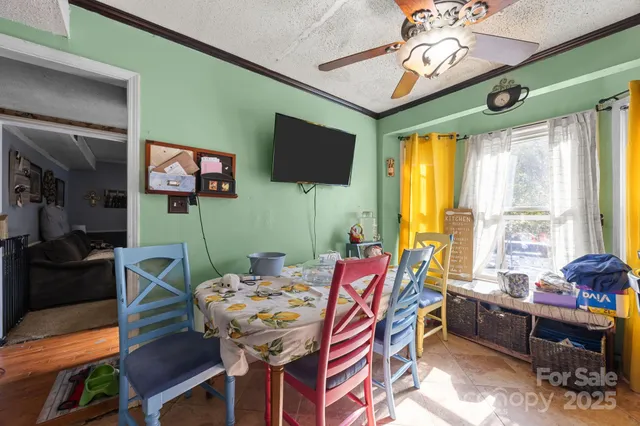 a dining room with furniture a flat screen tv and a large window