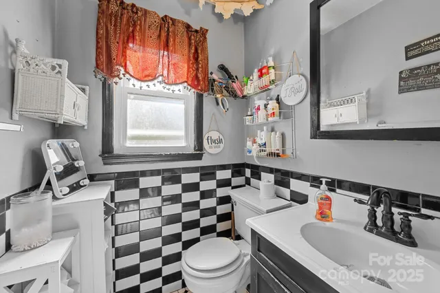 a bathroom with a sink toilet a mirror and shower