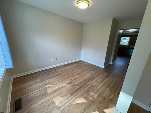 a view of a room with wooden floor