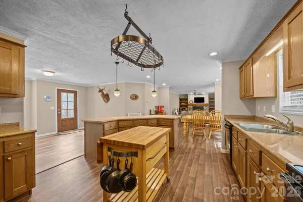 a kitchen with a table chairs stove and wooden floor