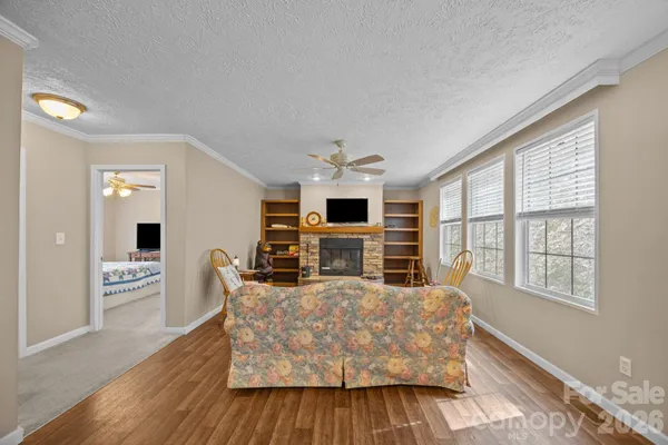 a living room with furniture fireplace and flat screen tv