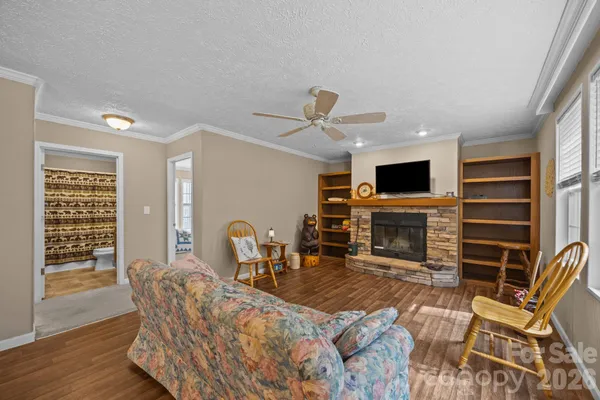 a living room with furniture a fireplace and a flat screen tv