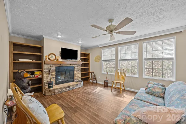a living room with furniture a fireplace and a flat screen tv