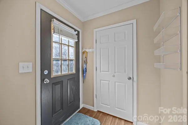 a view of front door with wooden floor
