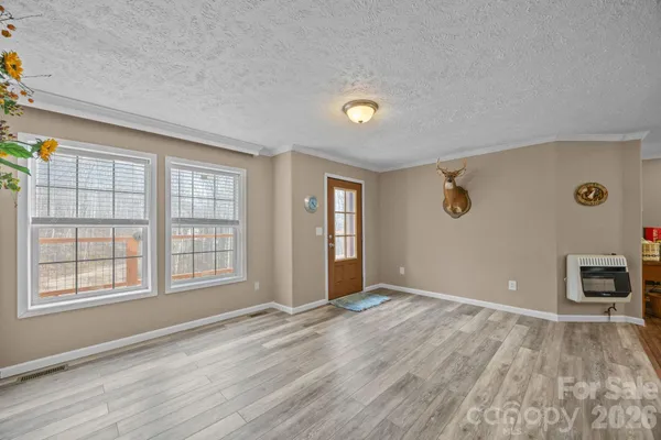 an empty room with windows and cabinet