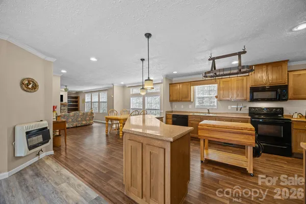 a kitchen that has a lot of cabinets and wooden floor