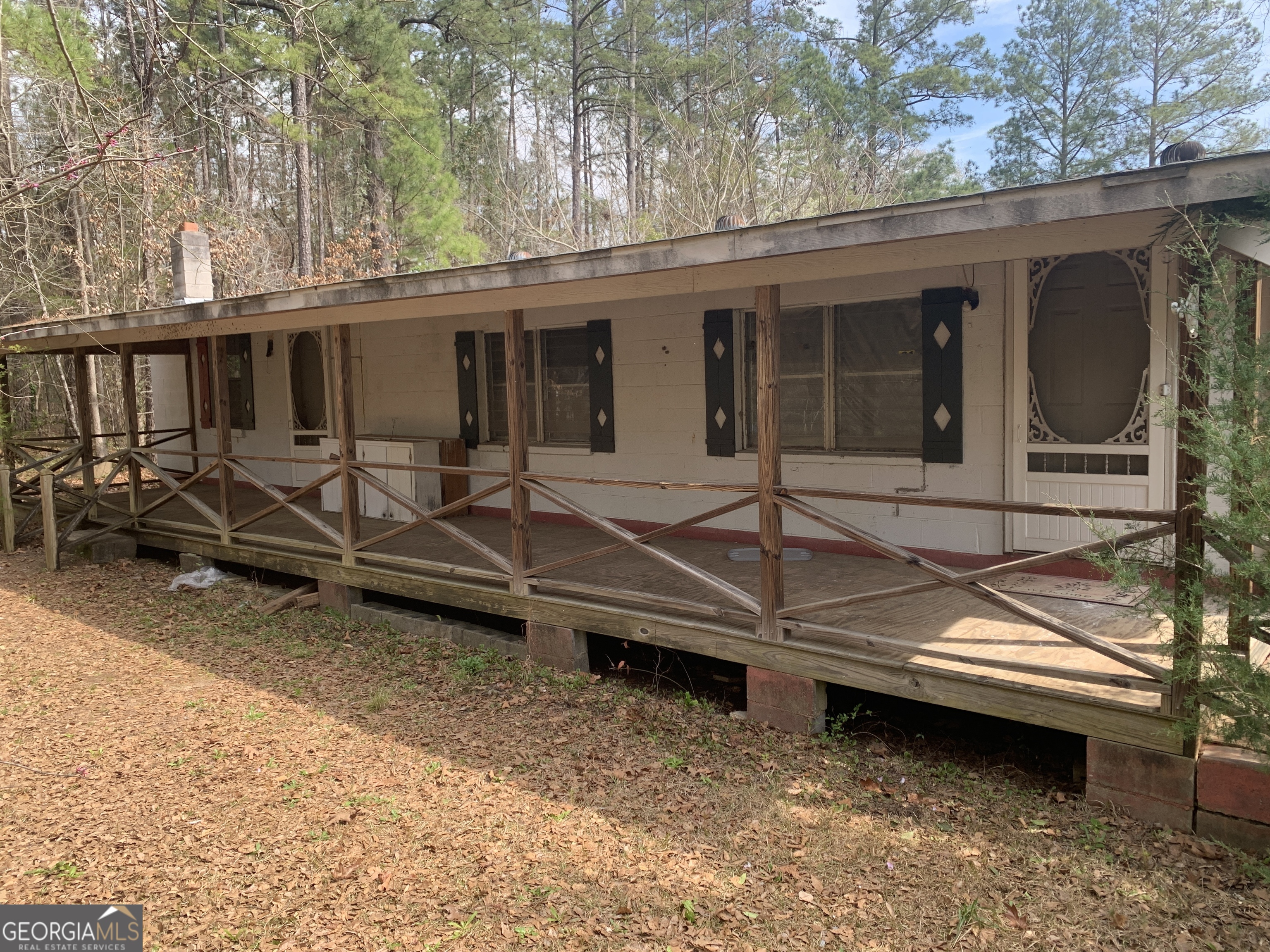 1065 3rd Street Tignall, GA 30668 - Photo 1 of 1 a view of a house with a large window and wooden fence