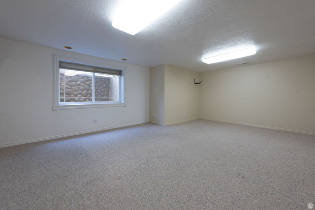875 East 1300th Street North Mapleton, UT 84664 - Photo 40 of 65 Empty room featuring carpet floors and a textured ceiling