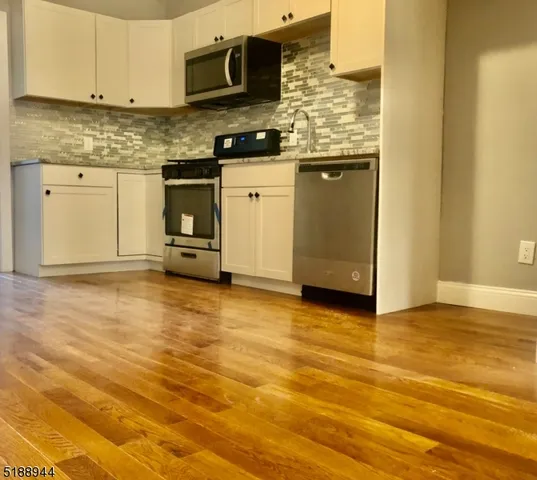 a kitchen with stainless steel appliances granite countertop a stove and a sink