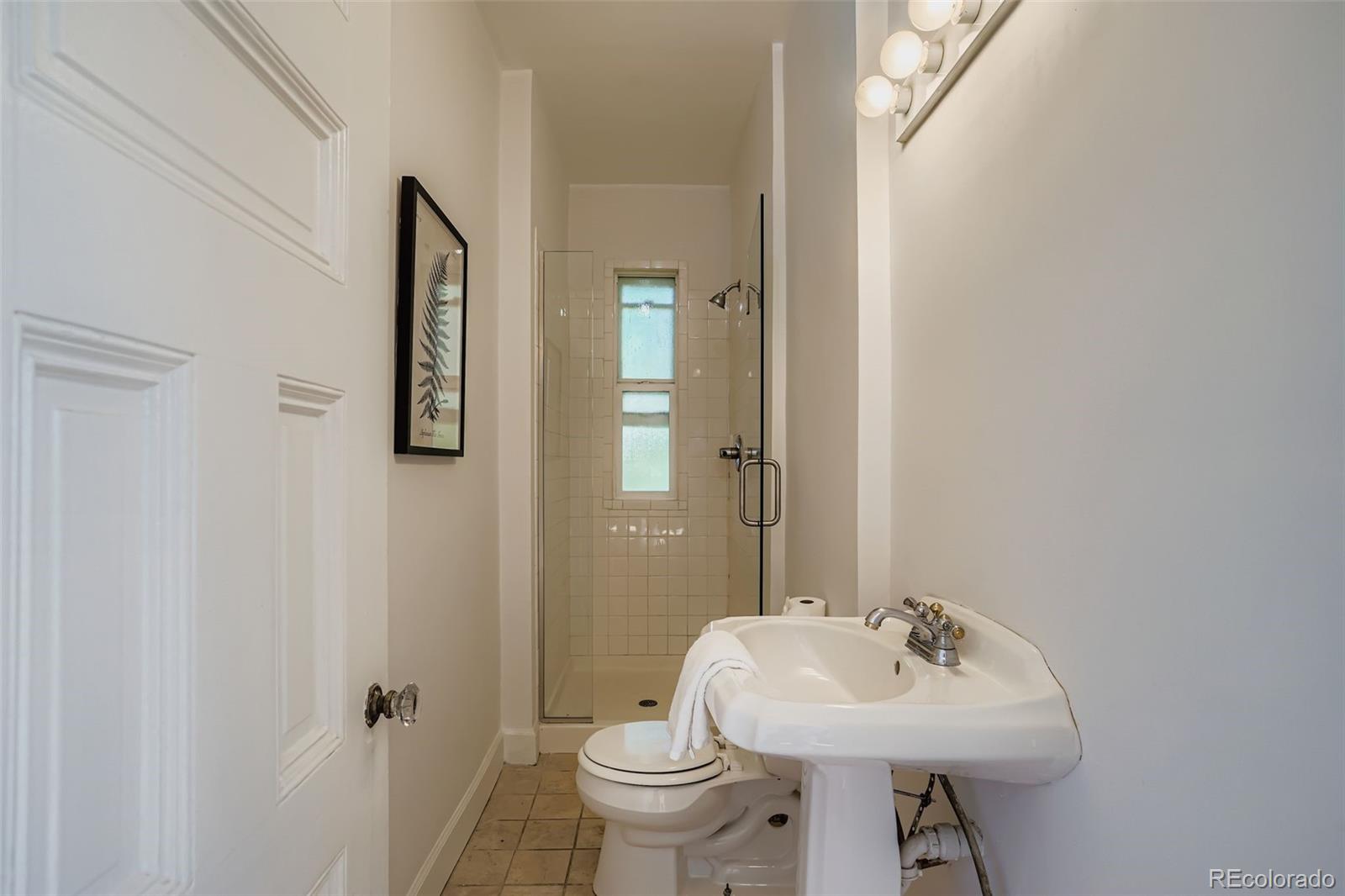 707 Corona Street Denver, CO 80218 - Photo 24 of 46 a bathroom with a sink toilet and mirror