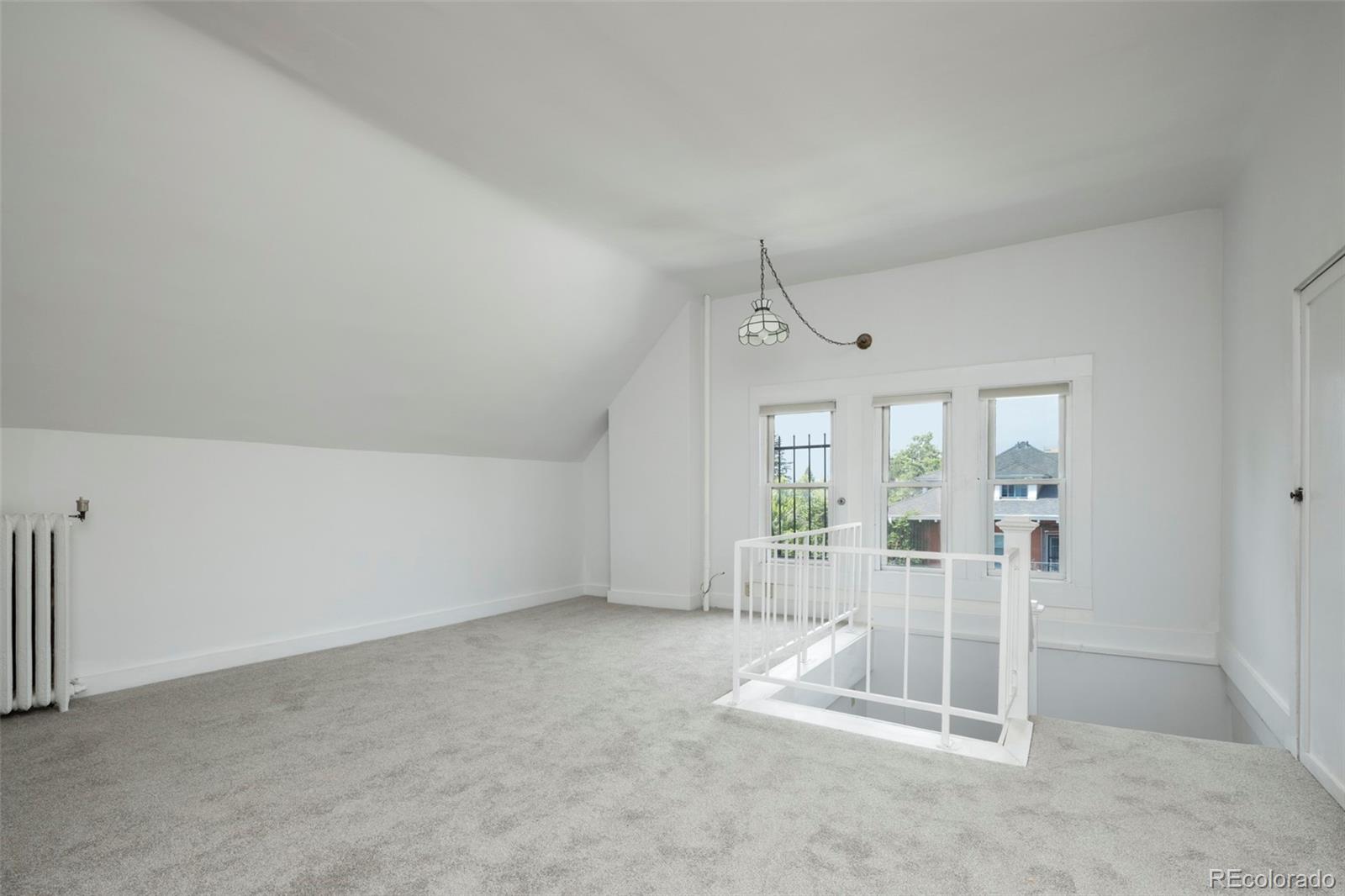707 Corona Street Denver, CO 80218 - Photo 25 of 46 a view of empty room with floor to ceiling window