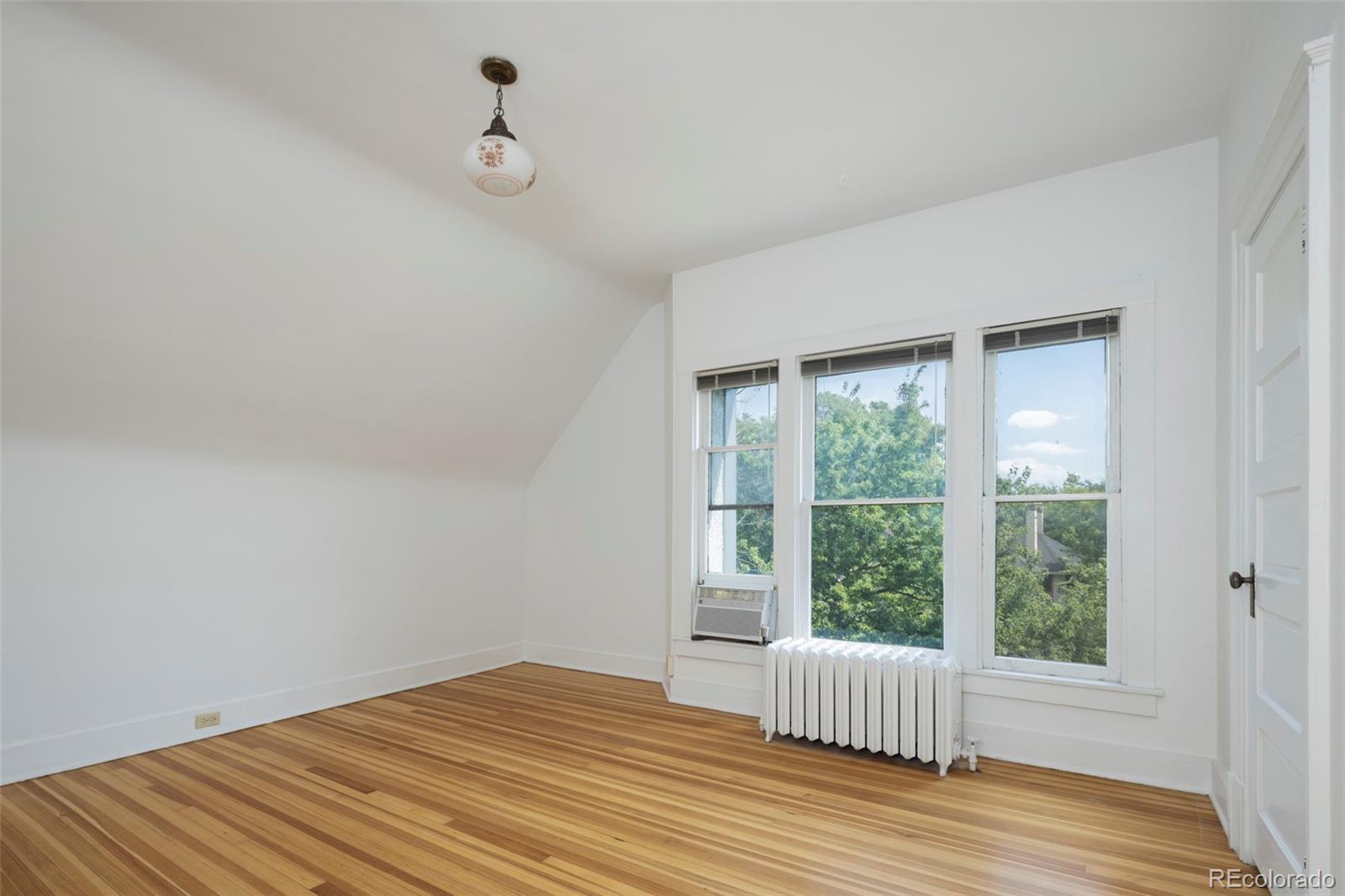 707 Corona Street Denver, CO 80218 - Photo 30 of 46 a view of empty room with wooden floor and fan