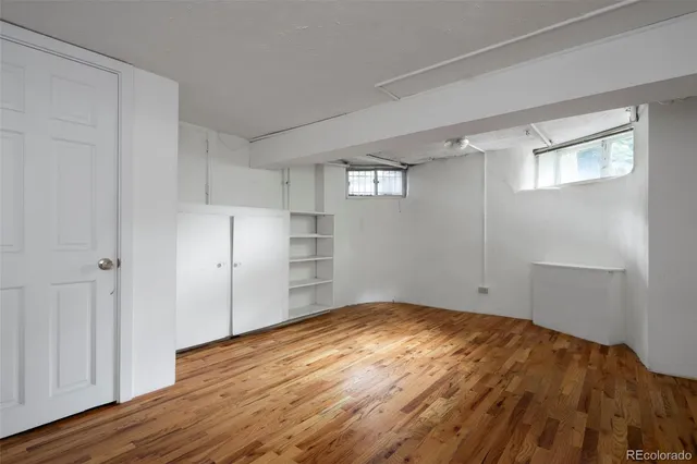 a view of a chair and table in backyard of the house