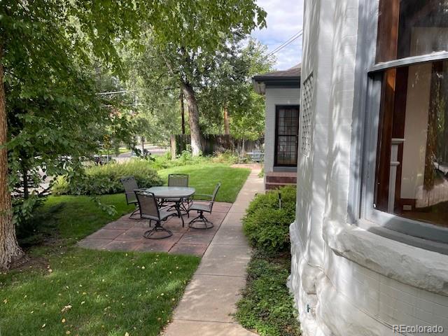 707 Corona Street Denver, CO 80218 - Photo 33 of 46 a view of a patio with table and chairs garden and plants