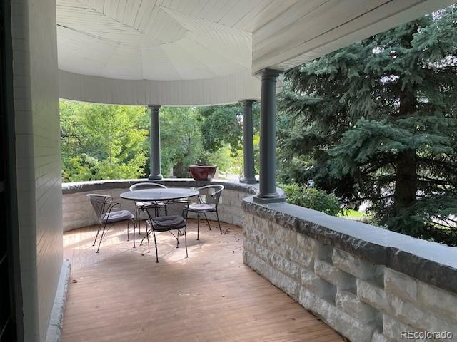 707 Corona Street Denver, CO 80218 - Photo 34 of 46 a view of a patio with chairs and floor to ceiling window