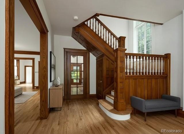 707 Corona Street Denver, CO 80218 - Photo 4 of 46 a view of entryway with wooden floor and stairs