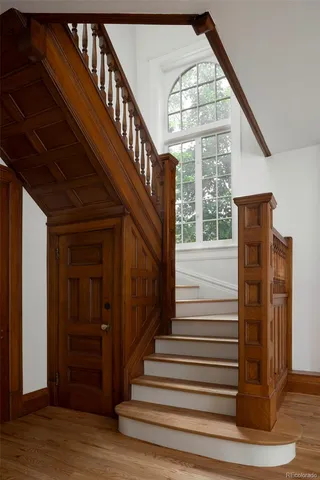 a dining room with furniture a fireplace and wooden floor