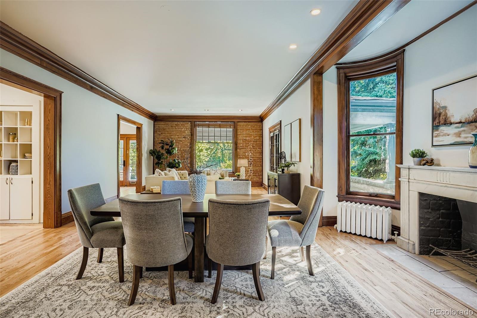 707 Corona Street Denver, CO 80218 - Photo 8 of 46 a view of a dining room with furniture window and wooden floor