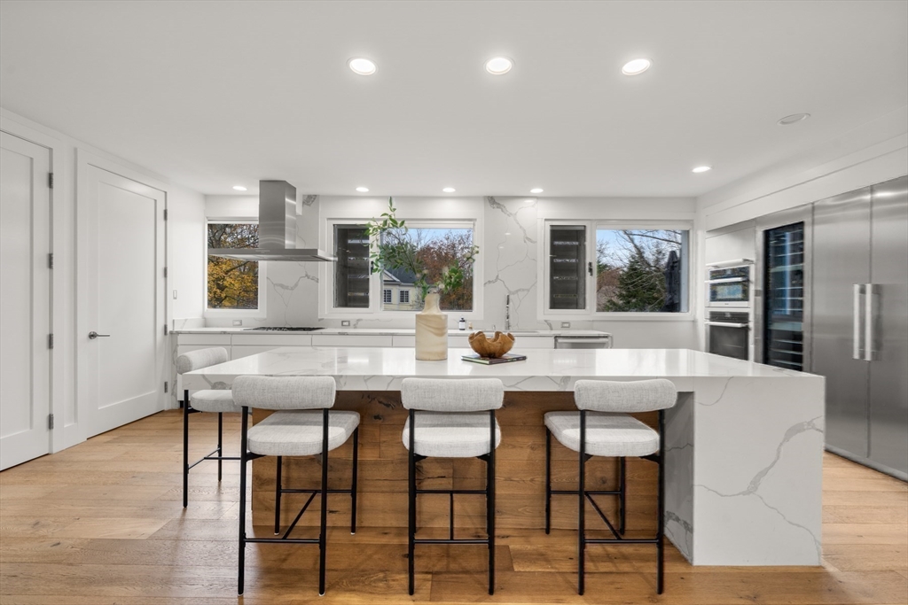 30 Whipple Road Lexington, MA 02420 - Photo 14 of 32 a dining hall with stainless steel appliances kitchen island granite countertop a dining table and chairs