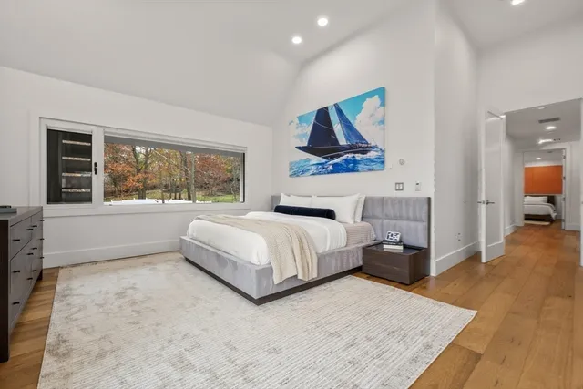 a bed room with a bed and a large window