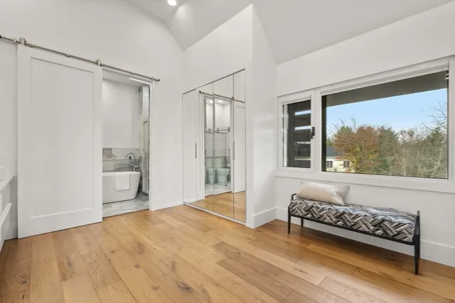 a spacious bedroom with a bed and a window