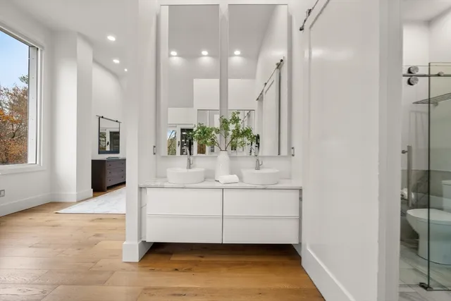 a view of a hallway with cabinet and mirror