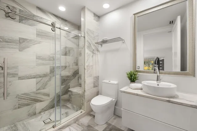 a bathroom with a toilet sink and shower