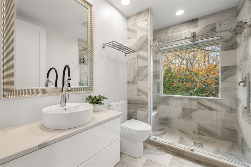 30 Whipple Road Lexington, MA 02420 - Photo 28 of 32 a bathroom with a sink toilet and shower