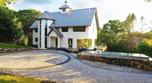 a view of house with yard and outdoor seating