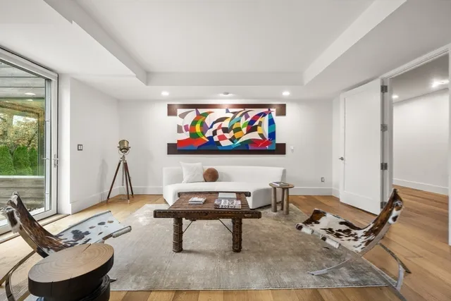 a living room with furniture a rug and white walls