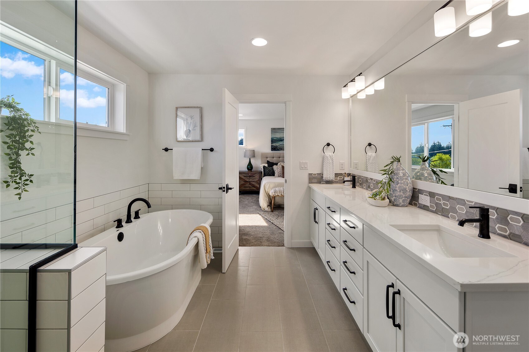 729 211th Place Southeast Bothell, WA 98021 - Photo 17 of 26 a large white bathroom with a double vanity sink a mirror and a bathtub