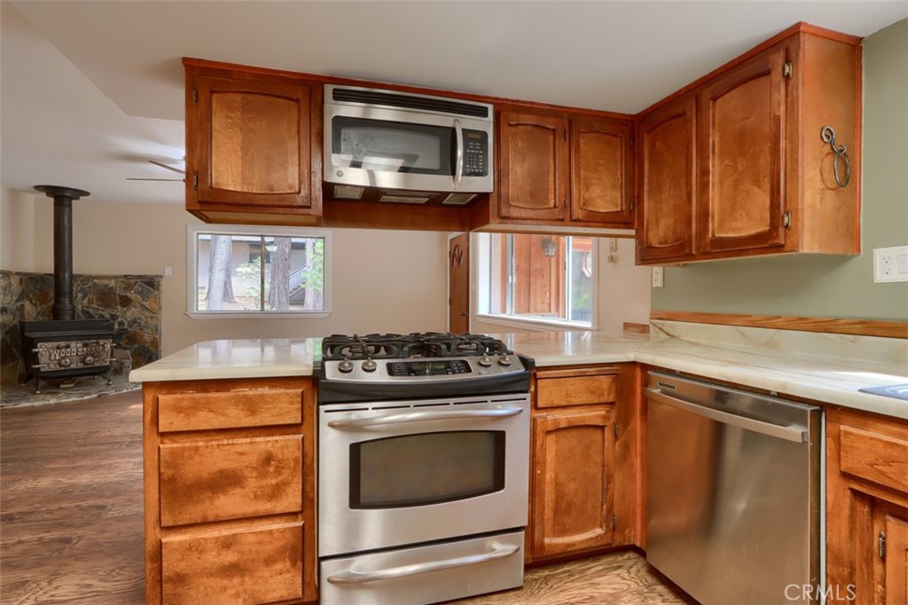 7115 Hites Cove Road Mariposa, CA 95338 - Photo 11 of 48 a kitchen with stainless steel appliances granite countertop a stove microwave and cabinets