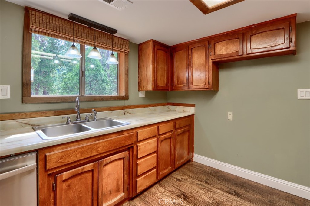 7115 Hites Cove Road Mariposa, CA 95338 - Photo 12 of 48 a kitchen with stainless steel appliances granite countertop a sink and a wooden cabinets