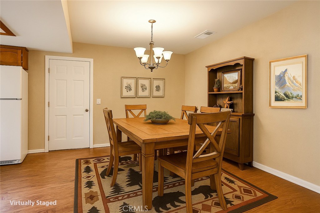 7115 Hites Cove Road Mariposa, CA 95338 - Photo 13 of 48 a view of a dining room with furniture and wooden floor
