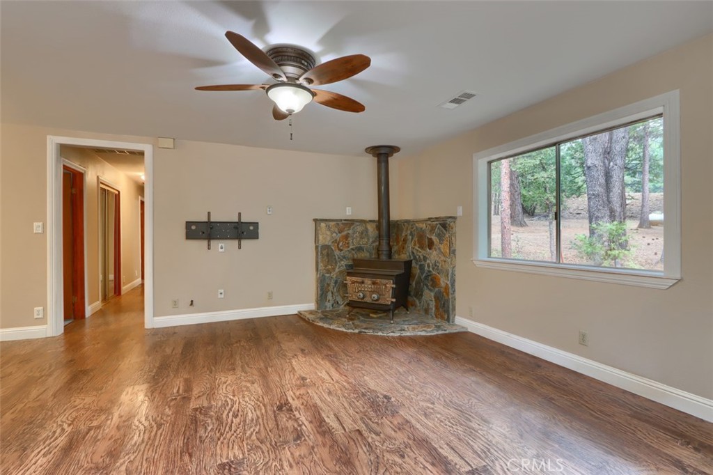 7115 Hites Cove Road Mariposa, CA 95338 - Photo 15 of 48 a view of empty room with wooden floor and fan