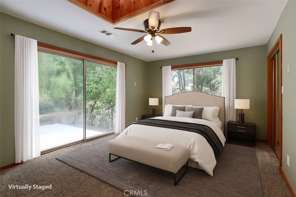 7115 Hites Cove Road Mariposa, CA 95338 - Photo 16 of 48 a bedroom with a balcony a bed and a large window