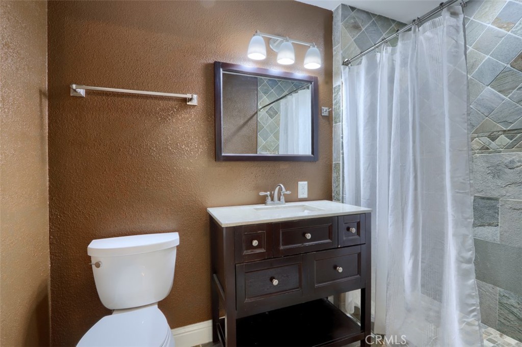 7115 Hites Cove Road Mariposa, CA 95338 - Photo 20 of 48 a bathroom with a toilet a sink and mirror