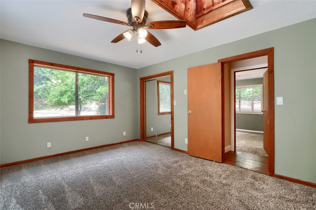 7115 Hites Cove Road Mariposa, CA 95338 - Photo 21 of 48 an empty room with chandelier fan and windows