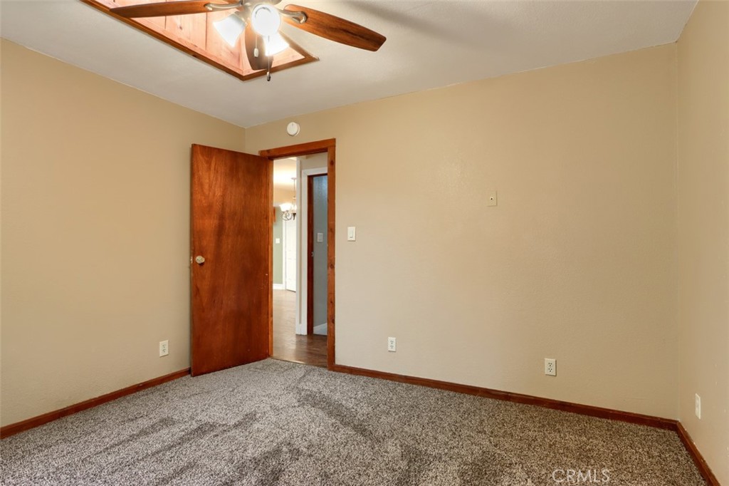 7115 Hites Cove Road Mariposa, CA 95338 - Photo 24 of 48 an empty room with a chandelier fan and closet