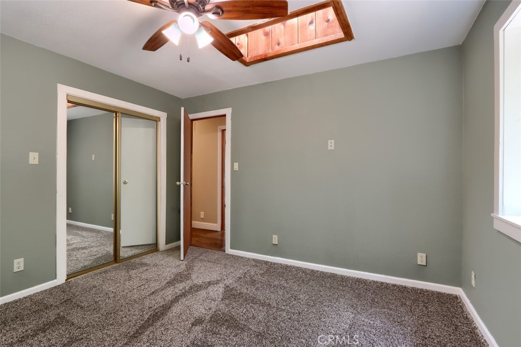 7115 Hites Cove Road Mariposa, CA 95338 - Photo 27 of 48 an empty room with chandelier fan and windows