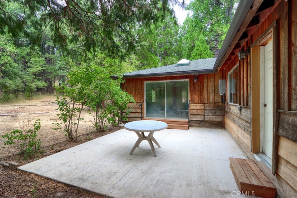 7115 Hites Cove Road Mariposa, CA 95338 - Photo 37 of 48 a view of a chair and table in backyard of the house
