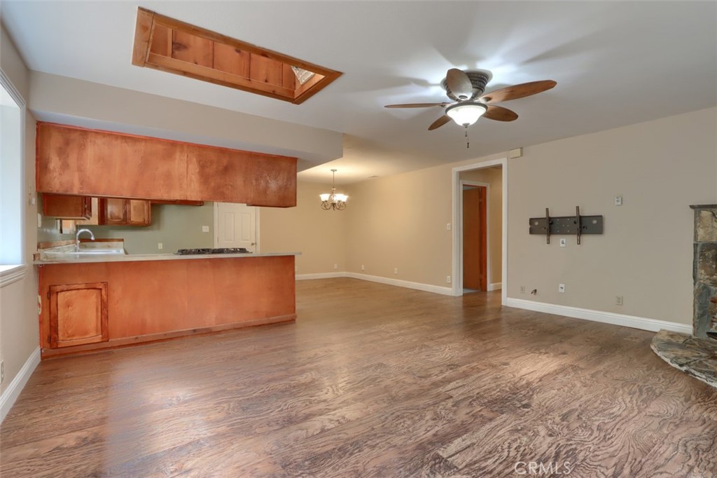 7115 Hites Cove Road Mariposa, CA 95338 - Photo 7 of 48 a view of a kitchen with a sink cabinetry and a ceiling fan