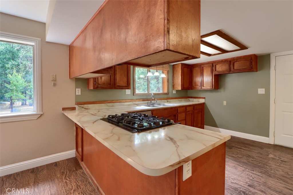 7115 Hites Cove Road Mariposa, CA 95338 - Photo 9 of 48 a kitchen with stainless steel appliances granite countertop a stove a sink and a microwave