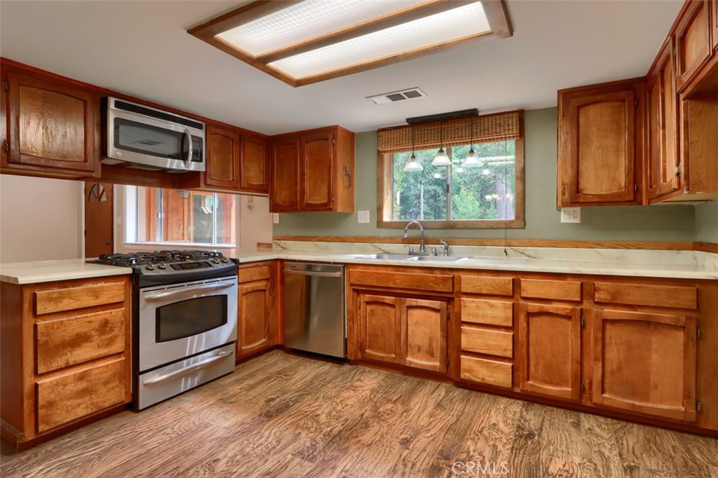 7115 Hites Cove Road Mariposa, CA 95338 - Photo 10 of 48 a kitchen with stainless steel appliances granite countertop a stove a sink and a microwave