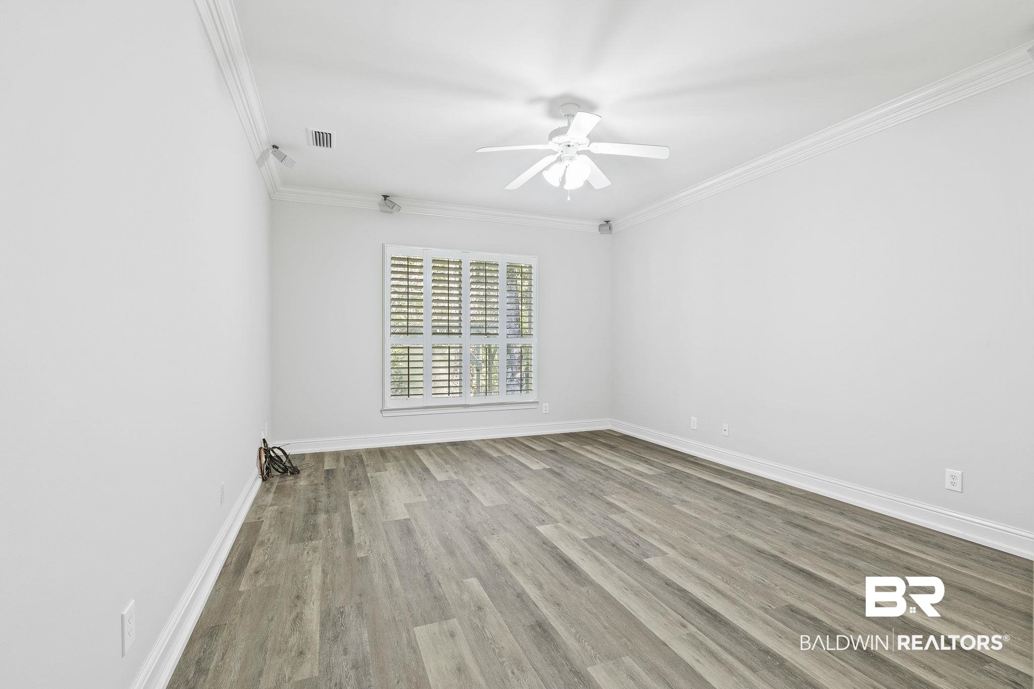 13 Bugle Retreat Daphne, AL 36527 - Photo 23 of 40 Spare room with crown molding, ceiling fan, and light wood-type flooring